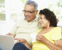 Image of senior couple looking at a computer