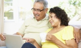 [Image of man and woman looking at computer together] Click button below to read privacy policy